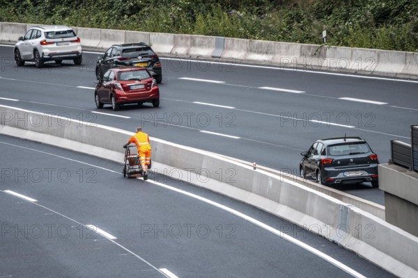 Rehabilitation of the A52 motorway near Essen, an 8 km long section between the Essen-Kettwig junction and the Essen-Ost motorway junction was completely rehabilitated over a period of 9 years, 6 lanes, new drainage pipes, carriageway, bridges, noise barriers, traffic facilities, here the last section, in the direction of Düsseldorf, new carriageway surface, laying of porous asphalt, whispering asphalt, marking work on the new carriageway, at the Essen-Rüttenscheid junction, North Rhine-Westphalia, Germany