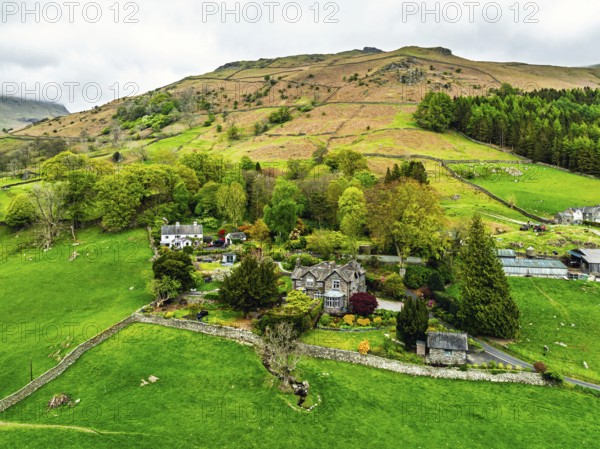 Farms and Mountains over road A591 from a drone, Grasmere Lake, Grasmere, Ambleside, Lake District, Westmorland, Cumbria, UK