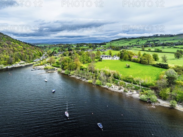 Farms and mountains over Ullswater Lake from drone, Pooley Bridge, Lake District National Park, Cumbria, England, United Kingdom