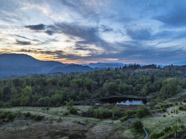 Sunset over Mountains and Coniston Water from drone, Lake District National Park, Cumbria, England, United Kingdom
