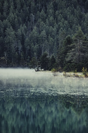 Sunrise with reflections in Lake Heiterwanger See in Tyrol in the Alps in Austria