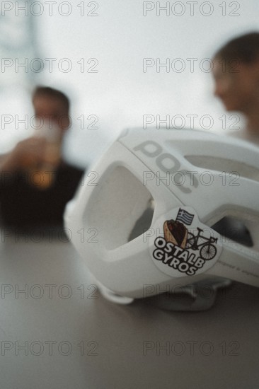 Young man taking a coffee break while riding his racing bike on Lake Garda. Sunny weather and dolce vita