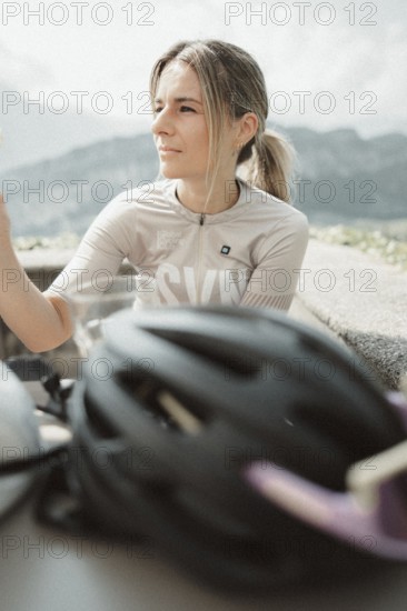 Young woman riding a racing bike on Lake Garda. Sunny weather and dolce vita