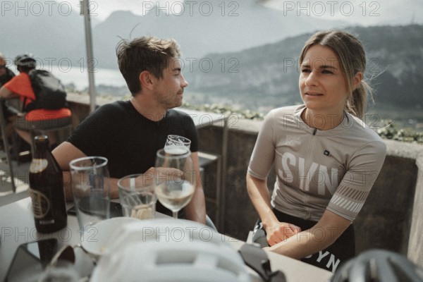 Young man taking a coffee break while riding his racing bike on Lake Garda. Sunny weather and dolce vita
