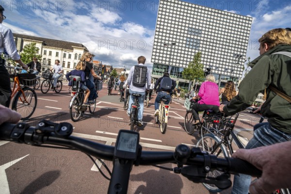 Ride your bike on the central cycle path on Lange Viestraat, Vredenburg, in the city centre of Utrecht, lanes for pedestrians, cyclists and public transport vehicles are separated, heavy cycle traffic, Netherlands