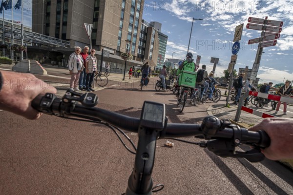 Cycle along the Jaarbeursplein, south of Utrecht Central, HBF, on the central cycle path in the city centre of Utrecht, lanes for pedestrians, cyclists and vehicles are separated, heavy cycle traffic, Netherlands