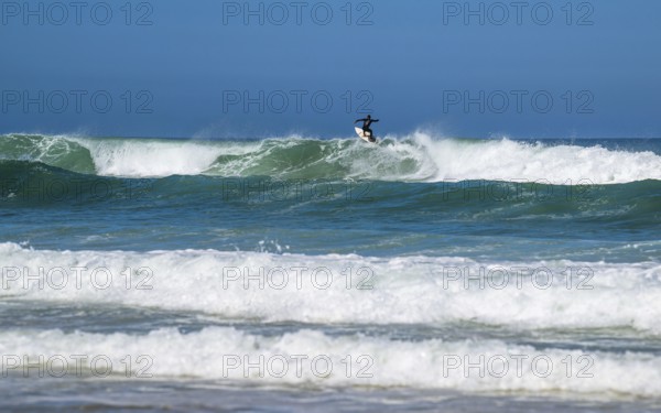 Surfer riding a wave on Contis beach, Saint Julien en Born, Saint-Julien-en-Born, Landes, France