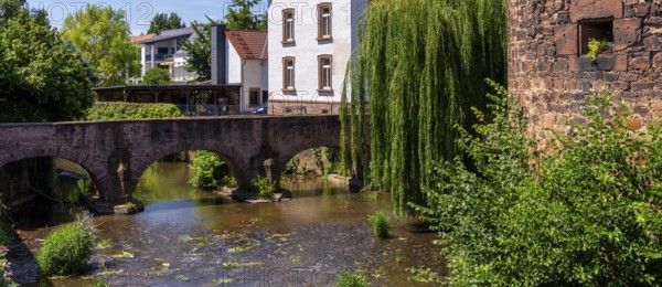 The old town centre with the town wall and the Seemenbach stream, Büdingen, Hesse, Germany