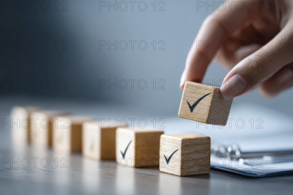 Checklist and task progress tracking concept. A hand placing the final checkmark on wooden blocks in a progress bar, AI generated