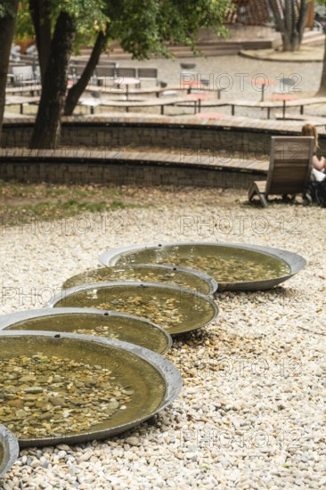 Small park with seating, a playground and a fountain at the entrance to Trencin Castle, Capital of Culture 2026, Trencín, Slovakia