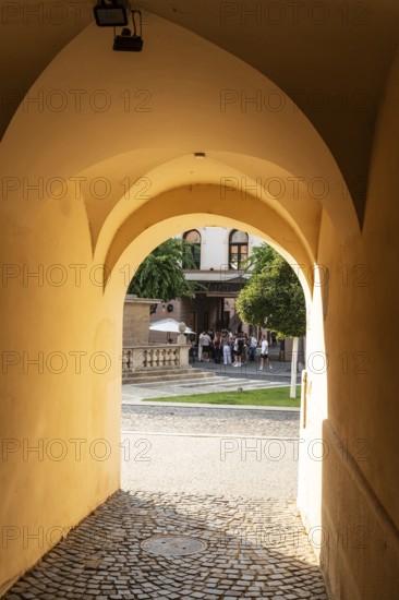 Alley with a view of the square and the Plague Column in the historic centre of the Capital of Culture 2026, Trencín, Slovakia