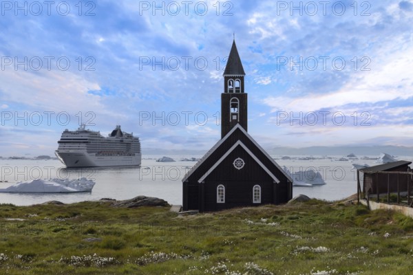 Typical architecture of Greenland Ilulissat with colored houses located near fjords and icebergs