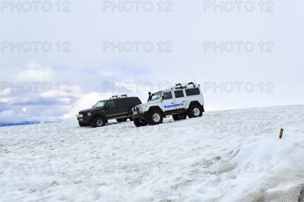 Two super jeeps parked next to each other in deep snow, glacier tour, Langjökull glacier, Husafell, Iceland