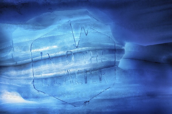 Faded logo with inscription, engraving in melting ice, Into the Glacier, ice tunnel, glacier cave, Langjökull glacier, Husafell, Iceland