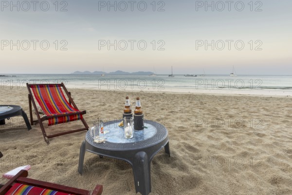 Abandoned deckchairs and parasol after sunset at Charlie Beach, Koh Mook Island, Andaman Sea, Thailand, Southeast Asia