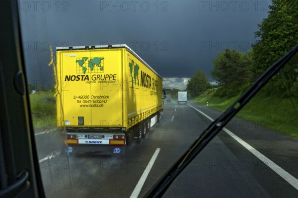 Overtaking manoeuvre of articulated lorry, lorry overtaking in thunderstorm, heavy rain, poor visibility, black sky, aquaplaning, A9 motorway near Pfaffenhofen, Upper Bavaria, Bavaria, Germany