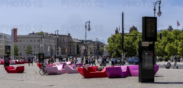 Colourful seating elements on the open space in front of the entrance to the Humboldt Forum, Berlin, Germany