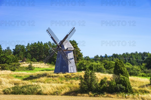 Historic windmill in an epic summer landscape near the burial ground of Stenhusbacken and the village of Sunnersberg near Lidköping, Västergötland, Västra Götalands län, Sweden
