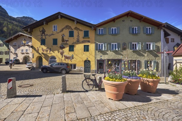 Old town, historic houses, air fresco, facade, windows, doors, square, alleyway, cobblestones, sandstone slabs, vehicles, bollards, flower pots, blue sky, Sebastianigasse, Florianiplatz, Bad Reichenhall, Berchtesgadener Land district, Bavaria, Germany