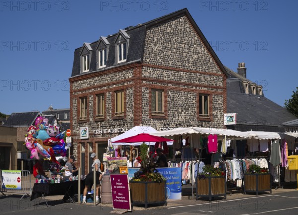 Weekly market with regional products, behind it co-operative bank, savings bank Crédit Agricole, Étretat, Normandy, Seine-Maritime, France