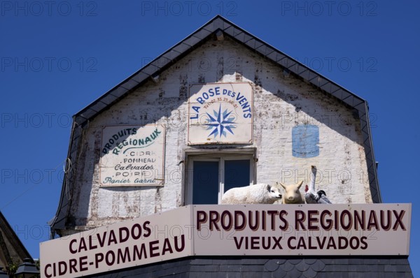 Advertising sign La Rose des Vents. Retail trade, supplier of regional products such as Calvados, advertising, advertising with figures, animal figures, sheep, pig, goose, rooster, Étretat, Normandy, Seine-Maritime, France