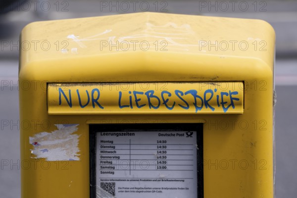 Deutsche Post letterbox, with stickers and graffiti, labelled Only love letters, Leverkusen, North Rhine-Westphalia, Germany