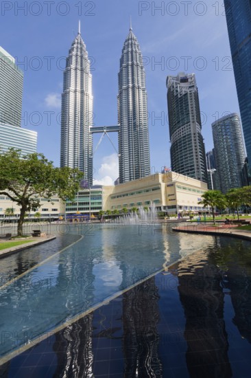 Petronas twin towers and Symphony Lake in KLCC park, Kuala Lumpur, Malaysia, Asia