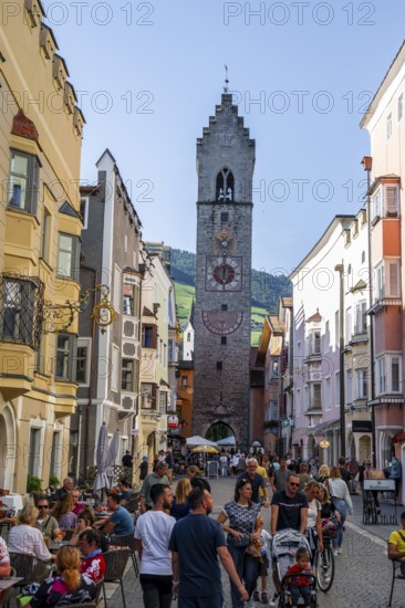 Old town, colourful houses in the main street, Zwölferturm tower at the back, old town, Sterzing, South Tyrol, Italy
