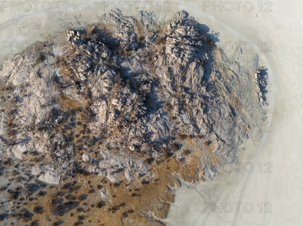 Rocky island with baobab trees in a dry salt pan, top down, aerial view, Kubu Island, Botswana