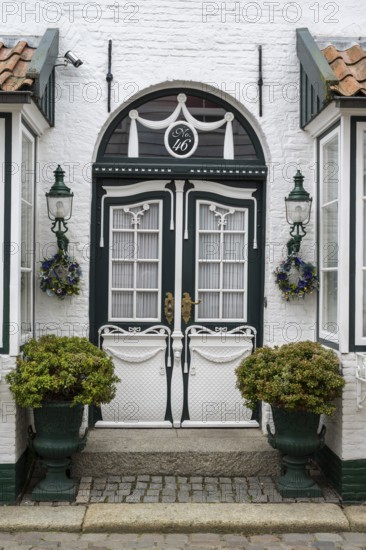Beautiful ornate door with lamps, facade, Old Town, Husum, North Frisia, Schleswig-Holstein, Germany