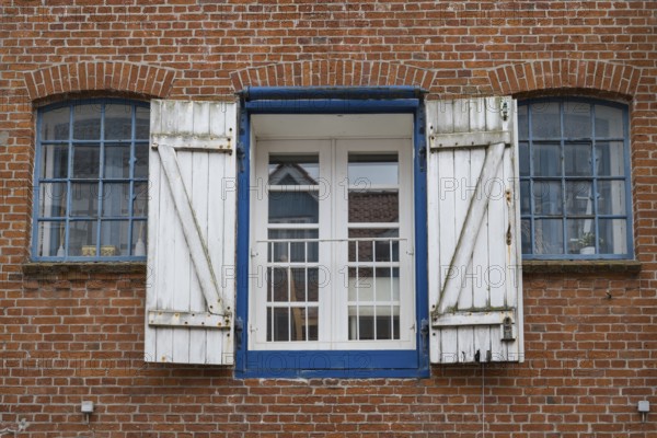 Window with shutters, brick façade, warehouse building, old town centre, Husum, North Frisia, Schleswig-Holstein, Germany