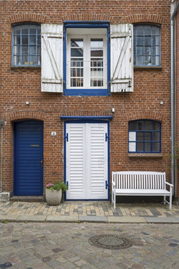 Window with shutters, brick façade, warehouse building, old town centre, Husum, North Frisia, Schleswig-Holstein, Germany