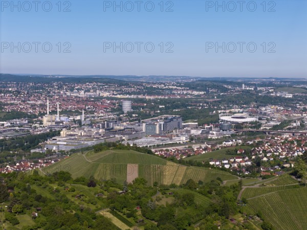 City panorama of Stuttgart with hills and vineyards, in the background the Mercedes-Benz plant in Stuttgart-Untertürkheim and the MHP Arena, Baden-Württemberg, Germany