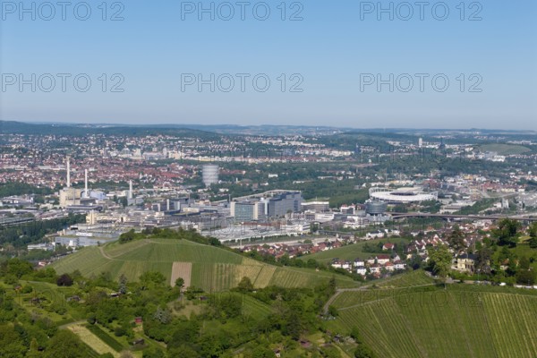 Panoramic view over the city of Stuttgart with vineyards in the foreground, in the background the Mercedes-Benz plant in Stuttgart-Untertürkheim and the MHP Arena, Baden-Württemberg, Germany