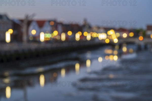 Buildings at the harbour, skyline, illuminated, blue hour, blurred, Husum, North Sea, North Frisia, Schleswig-Holstein, Germany