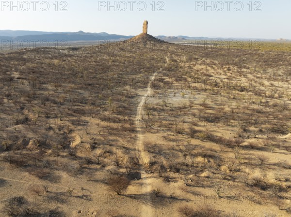 The Vingerklip (rock finger) is surrounded by thornbush and mopane (Colophospermum mopane) savanna. Aerial view. Drone shot. Damaraland, Namibia