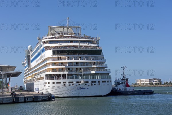 Cruise ship AIDA nova is pushed against the quay wall by tugboats, Warnow, Warnemünde, Rostock, Mecklenburg-Western Pomerania, Germany