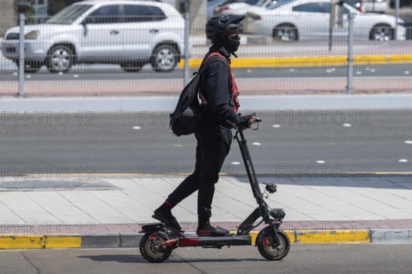 Man with electric scooter, Abu Dhabi, United Arab Emirates
