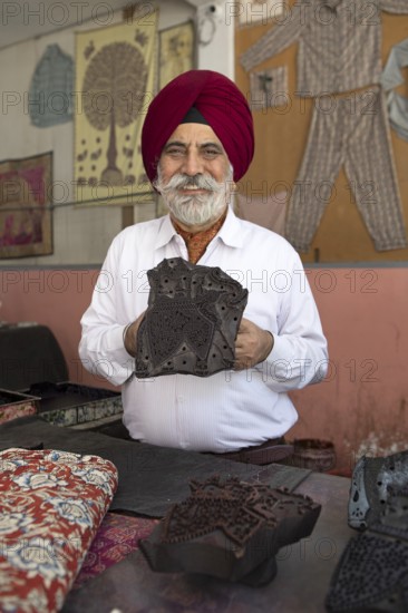 Indian Sikh, 68 years old, showing a wooden panel for woodblock printing, Jaipur, Rajasthan, India