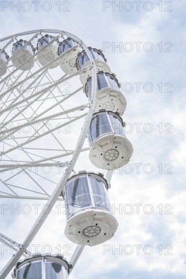 Close-up of a Ferris wheel and its gondolas under a cloudy sky, Ferris wheel construction for the 950th anniversary of the town of Calw, Black Forest, Germany