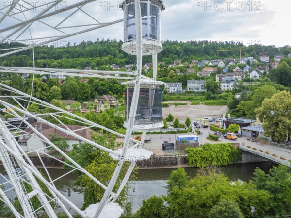 Panoramic view from the Ferris wheel of the river, town and green hills under a cloudy sky, Ferris wheel construction for the 950th anniversary of the town of Calw, Black Forest, Germany