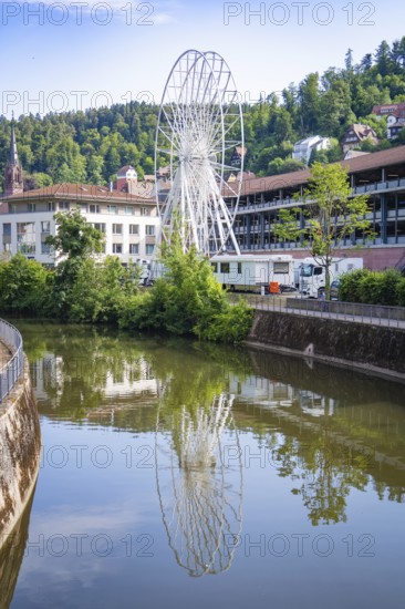 White Ferris wheel reflected in the river with surrounding buildings, Ferris wheel construction for the 950th anniversary of the town of Calw, Black Forest, Germany
