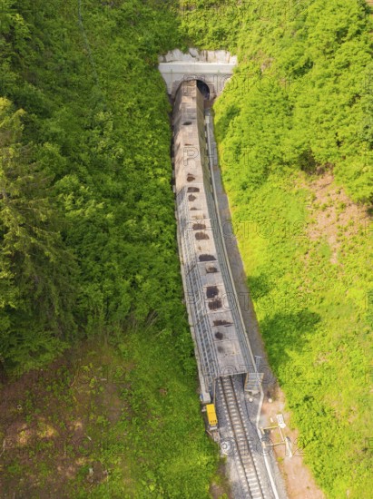 View from above of a railway tunnel surrounded by dense forests, construction of the Hermann Hesse Railway, Calw, Germany