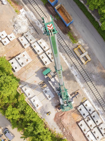 A crane on a building site, surrounded by rails and materials, construction of the Hermann Hesse railway, Calw, Germany