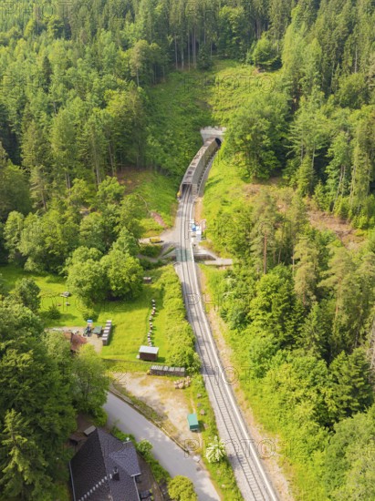 Aerial view of a railway tunnel running through a green, wooded landscape, construction of the Hermann Hesse Railway, Calw, Germany