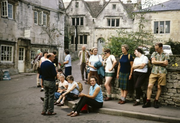 Group of ramblers meet together in town centre, Painswick, Gloucestershire, England, UK 1967