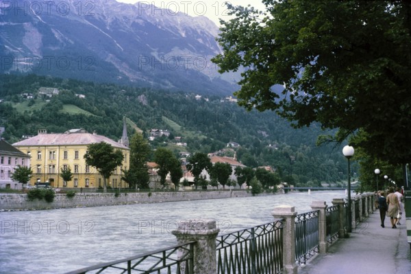 Historic waterfront buildings and pathway, River Inn, city of Innsbruck, Tyrol, Austria, Europe 1970