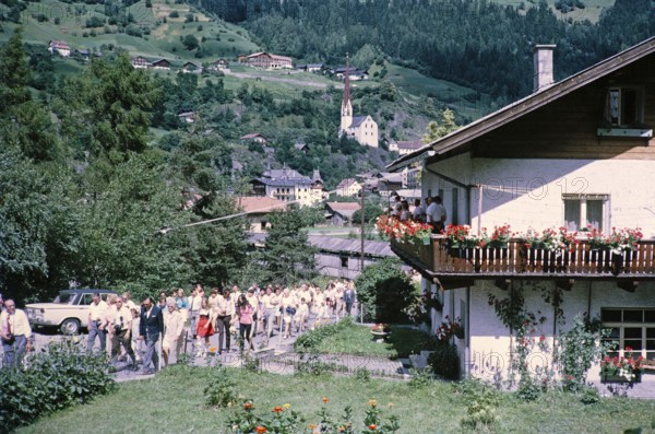 People in street procession through village of Oetz, Imst district, Tyrol, Austria, Europe, 1970