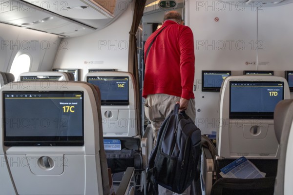 Etihad Airways passenger with backpack, Abu Dhabi, United Arab Emirates