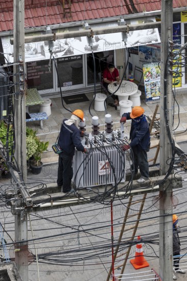 Electricians working on power lines, Pattaya, Thailand